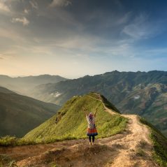photo-of-woman-standing-on-top-of-mountain-2161856